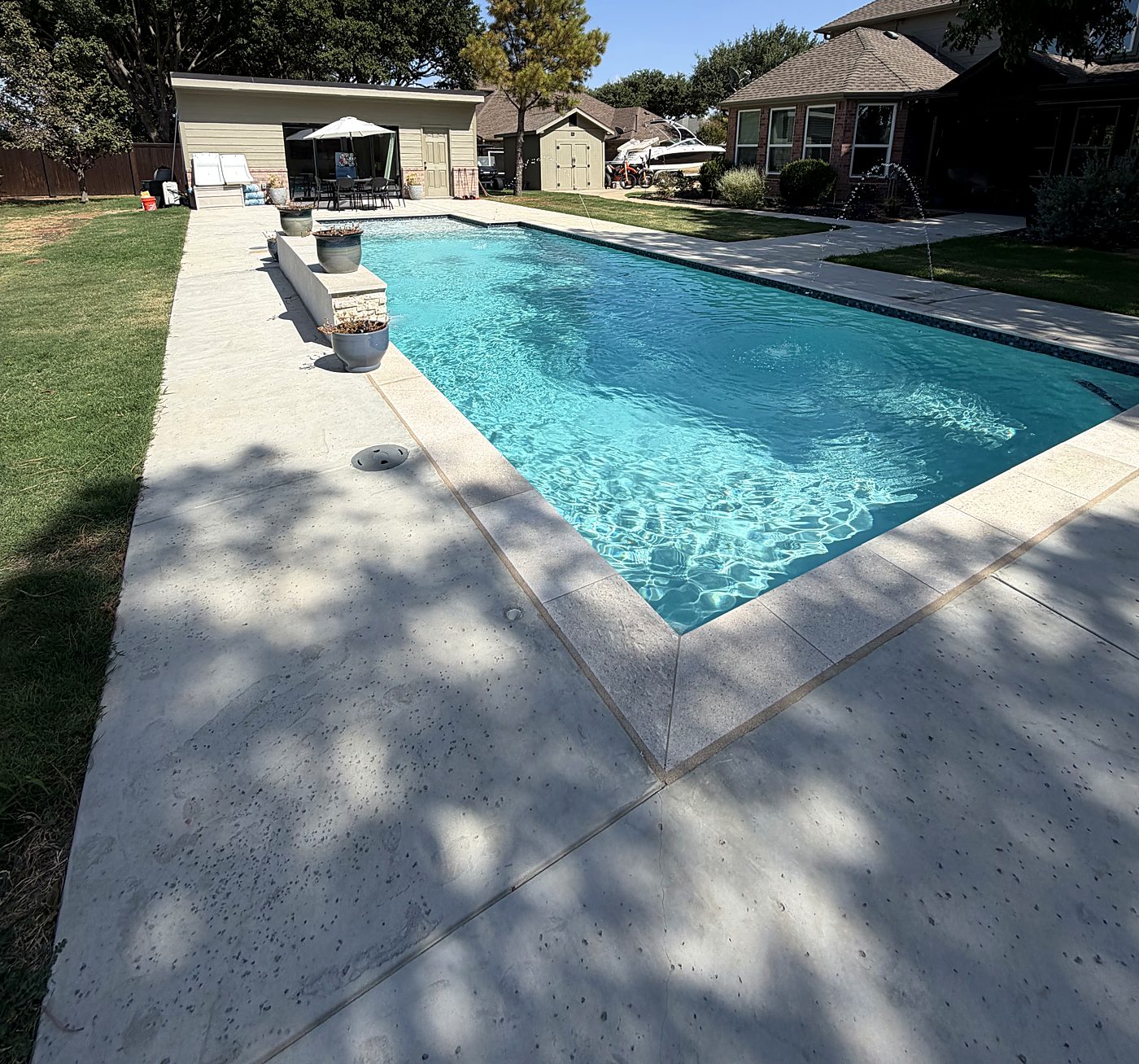 Pool with raised water feature wall and wide deck
