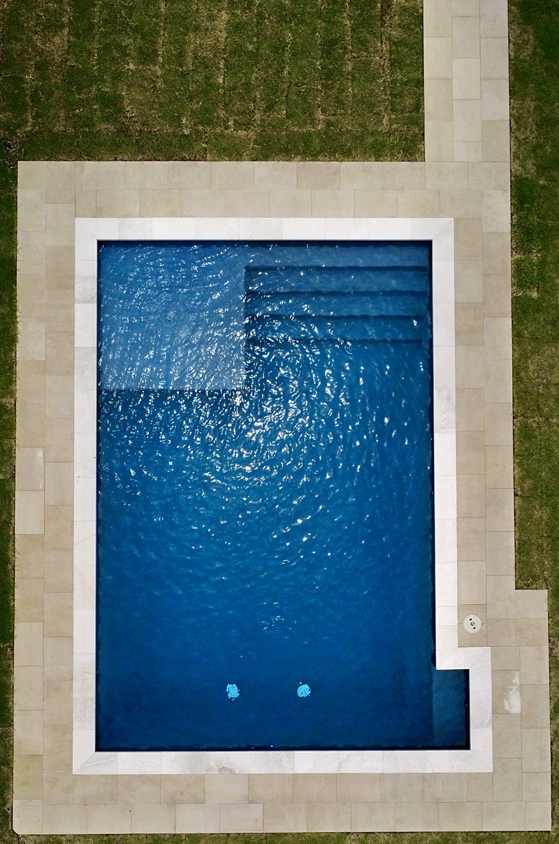 Overhead view of a pool with full-width entry steps