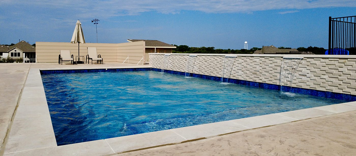 Pool with sheer descents along a raised wall